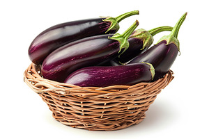 Fresh eggplants in basket isolated on white background, a Food & Drink Photo by AlyaAnd