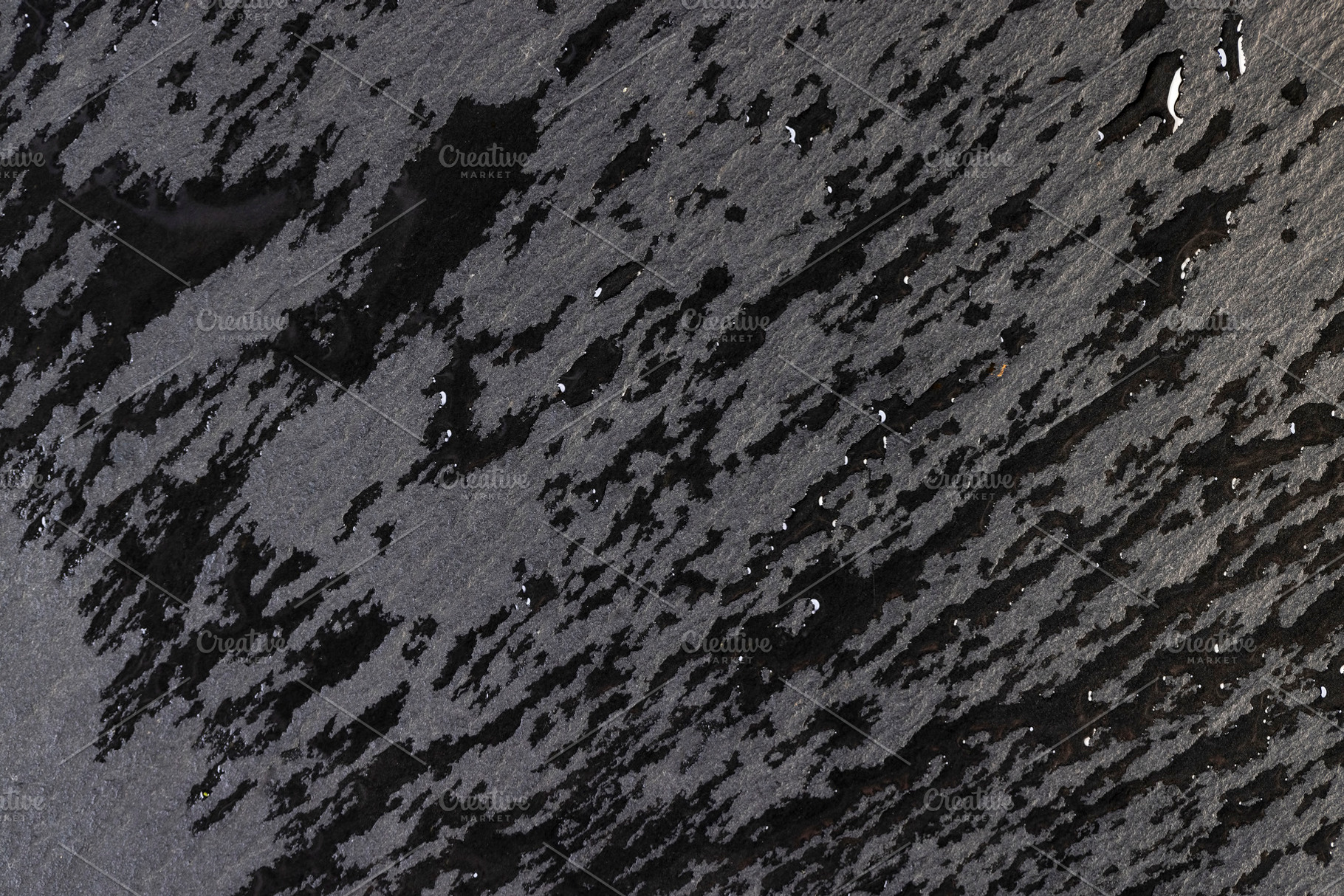 black wet slate that is used for the background, a Photo by rsoollAI