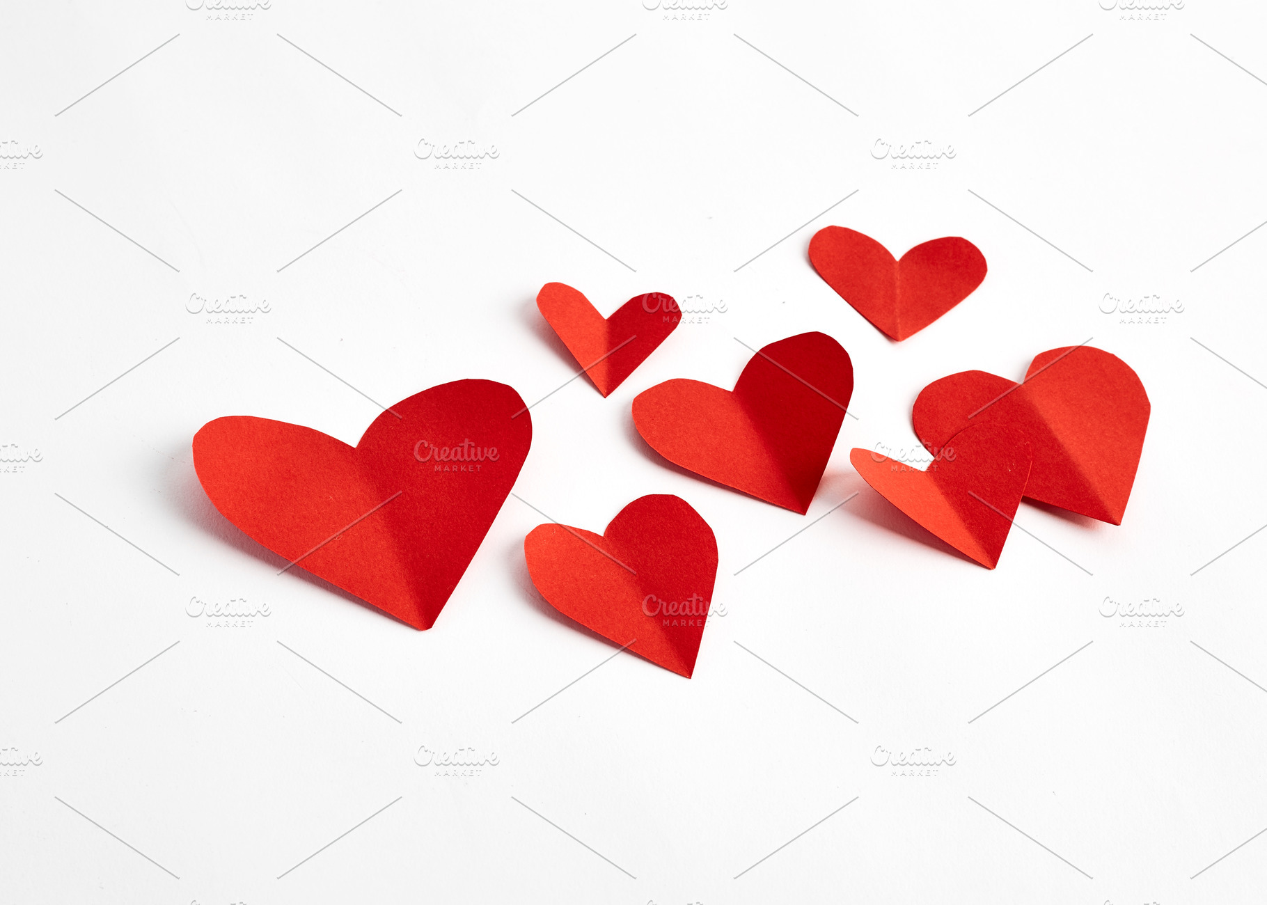 Red paper hearts isolated on white, a Background Photo by 1981 Rustic studio kan