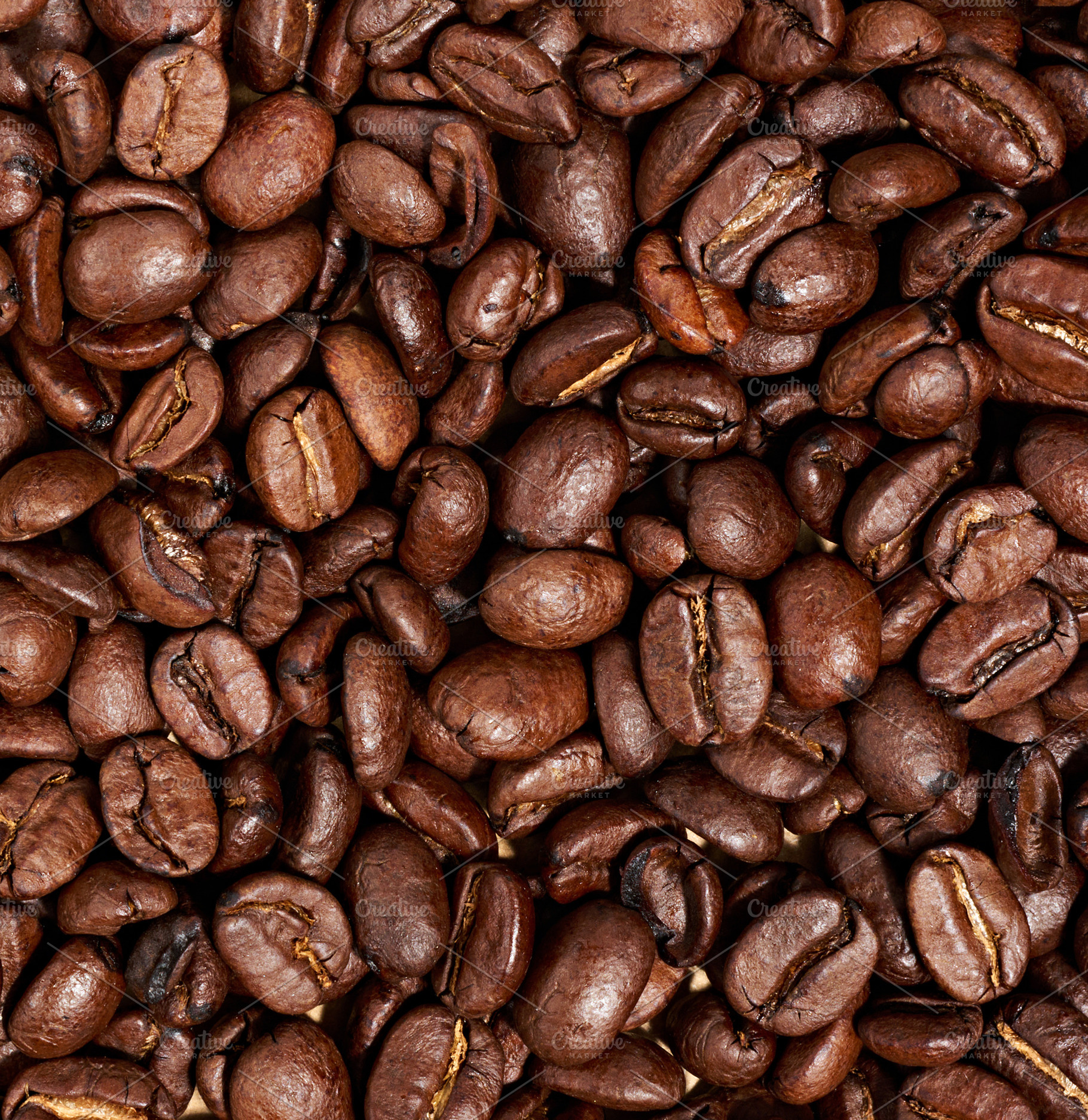 Whole roasted coffee beans scattered chaotically, a Food & Drink Photo by ndanko