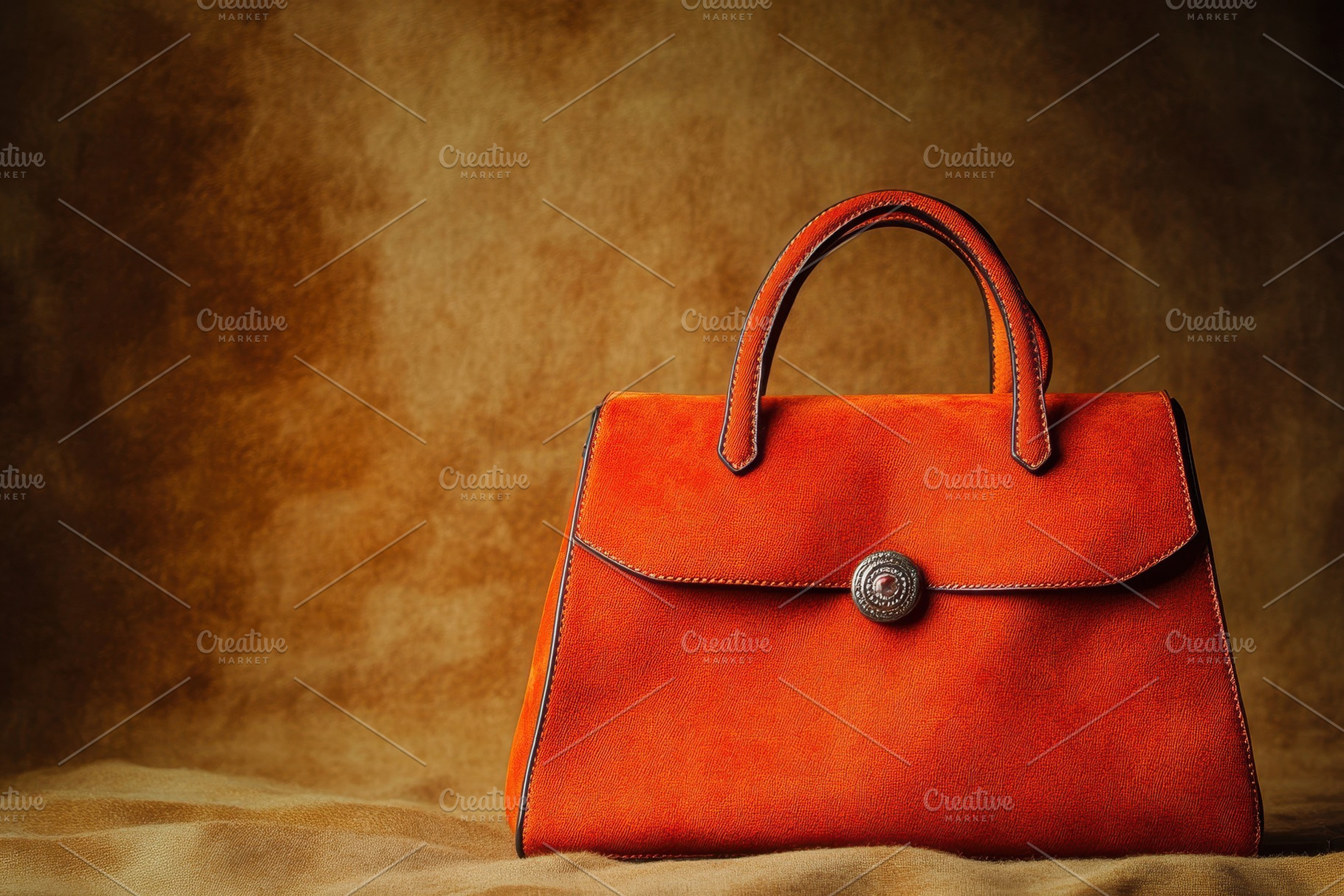 Elegant orange handbag showcased on, a Photo by Pavel_design