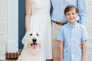 Happy family with son and pet dog standing together outdoors, sm, a Person Photo by Studio ANNA
