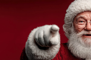 Happy Santa Claus smiling and pointing forward in red sweater an, a Person Photo by José Manuel Gelpi