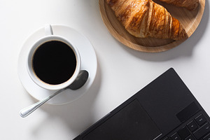 Breakfast with Coffee and Croissants on Home Office Desk, a Food & Drink Photo by etorres69