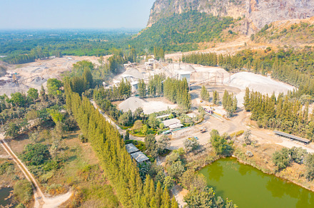 Aerial view of machine excavator trucks dig coal mining or ore w, a Background Photo by Tampatra