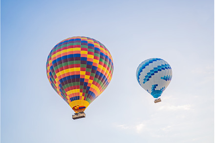 Beautiful hot air balloons over blue, a Transportation Photo by Elizaveta Galitskaya