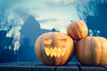 Halloween pumpkin on graveyard.
