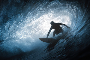 Surfer rides a wave in a powerful, a Photo by Pavel_design