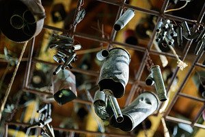 Various metal wind bullet chimes hanging artistically indoors under soft lighti, a Photo by AS photostudio