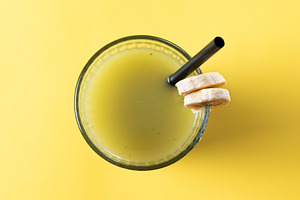 Green smoothie with banana, apple, and lemon on yellow background, a Food & Drink Photo by etorres69