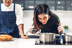 Young asian family couple having fun containing asia, sauce, and prepare