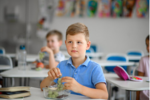 Children in the classroom eating a, a Food & Drink Photo by HalfPoint
