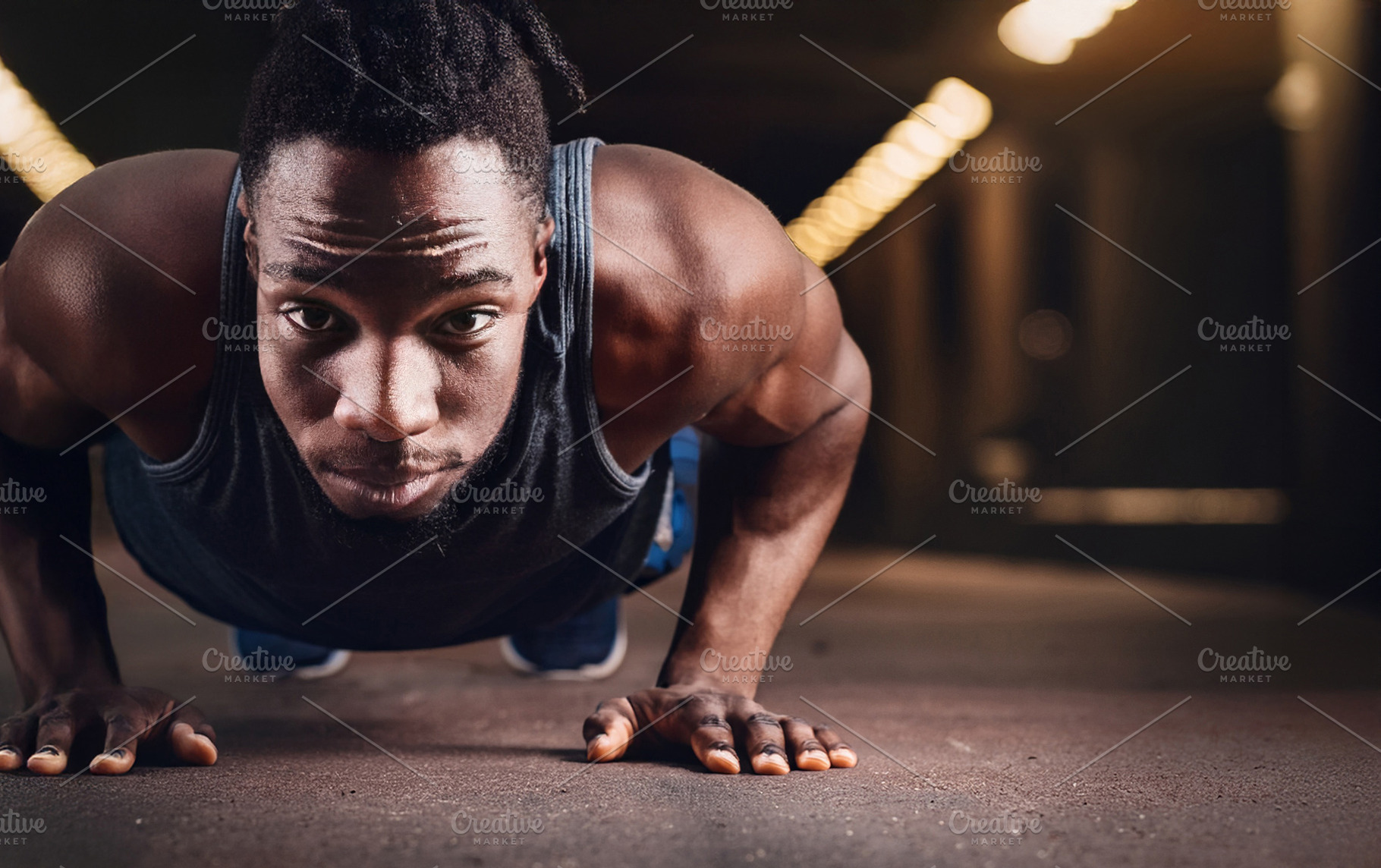 Young black man doing push-ups in gym looking, a Sports & Recreation Photo by Davizro's Market
