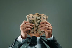 businessman, seen from below, with some dollars, a Photo by Nito