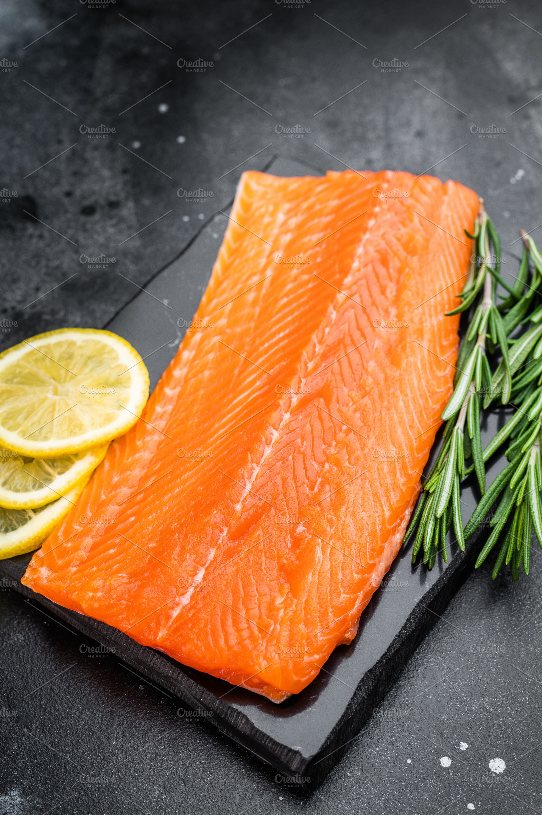 Fresh raw salmon fillet seafood ingredient with herbs and citrus, a Food & Drink Photo by composter-box@mail.ru