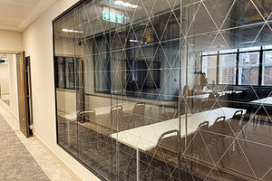 Modern glass conference room with a geometric patterned wall in a Manchester of, a Photo by AS photostudio