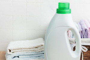 Detergent bottle, laundry and clean fresh towels, an Industrial Photo by Olena Rudo