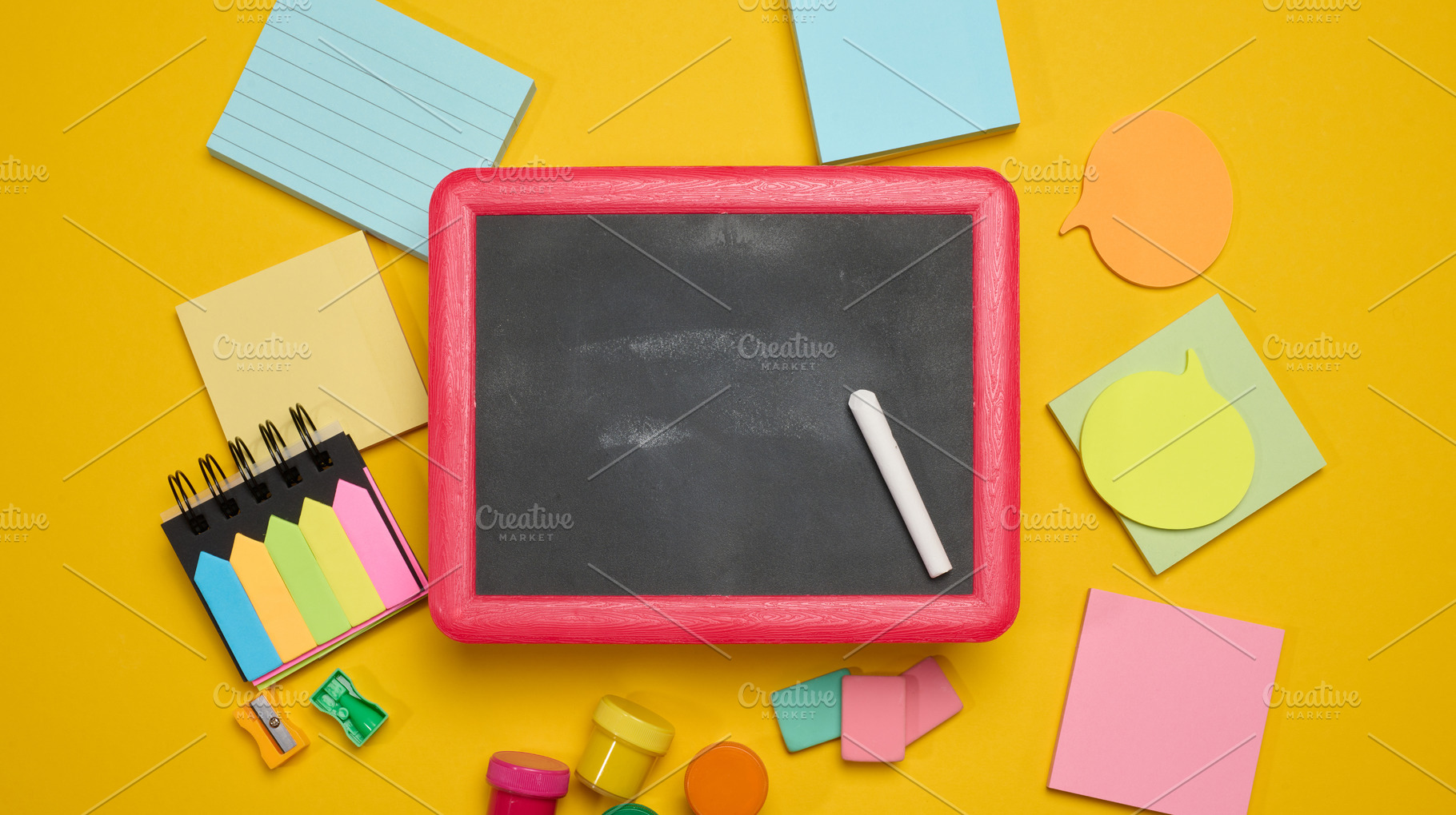 Chalkboard in a pink wooden frame with a piece of chalk, surroun, a School & Education Photo by ndanko