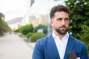 Confident businessman holding smartphone, a Business Photo by etorres69