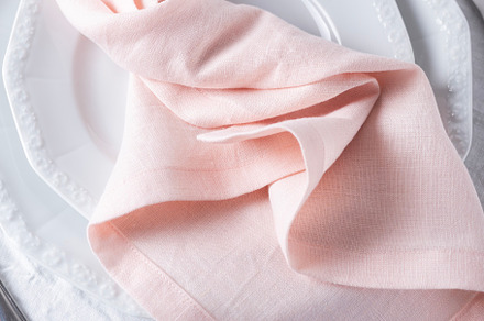 Pink linen napkins on the white table