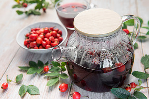 Steaming rosehip tea brewing in glass teapot with fresh rosehips, a Food & Drink Photo by Olena Rudo