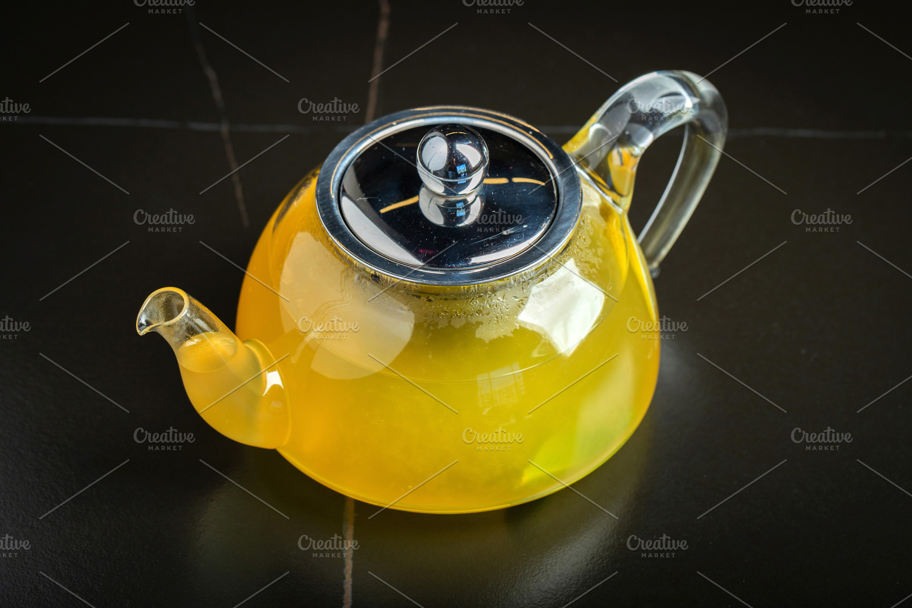 Fruit tea with mango and mint in a glass teapot on the table, a Food & Drink Photo by Budarinphoto