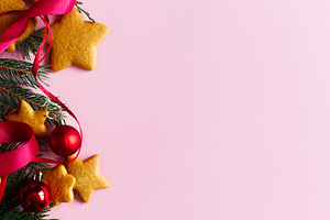 Christmas background with gingerbread cookies, red ribbon and ba, a Photo by Sonjachni