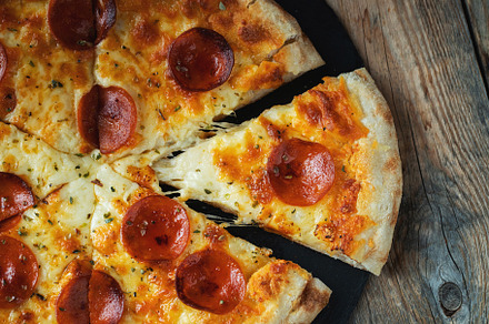 A slice of hot Italian pizza with stretching cheese. Pizza pepperoni on a dark, a Food & Drink Photo by Budarinphoto