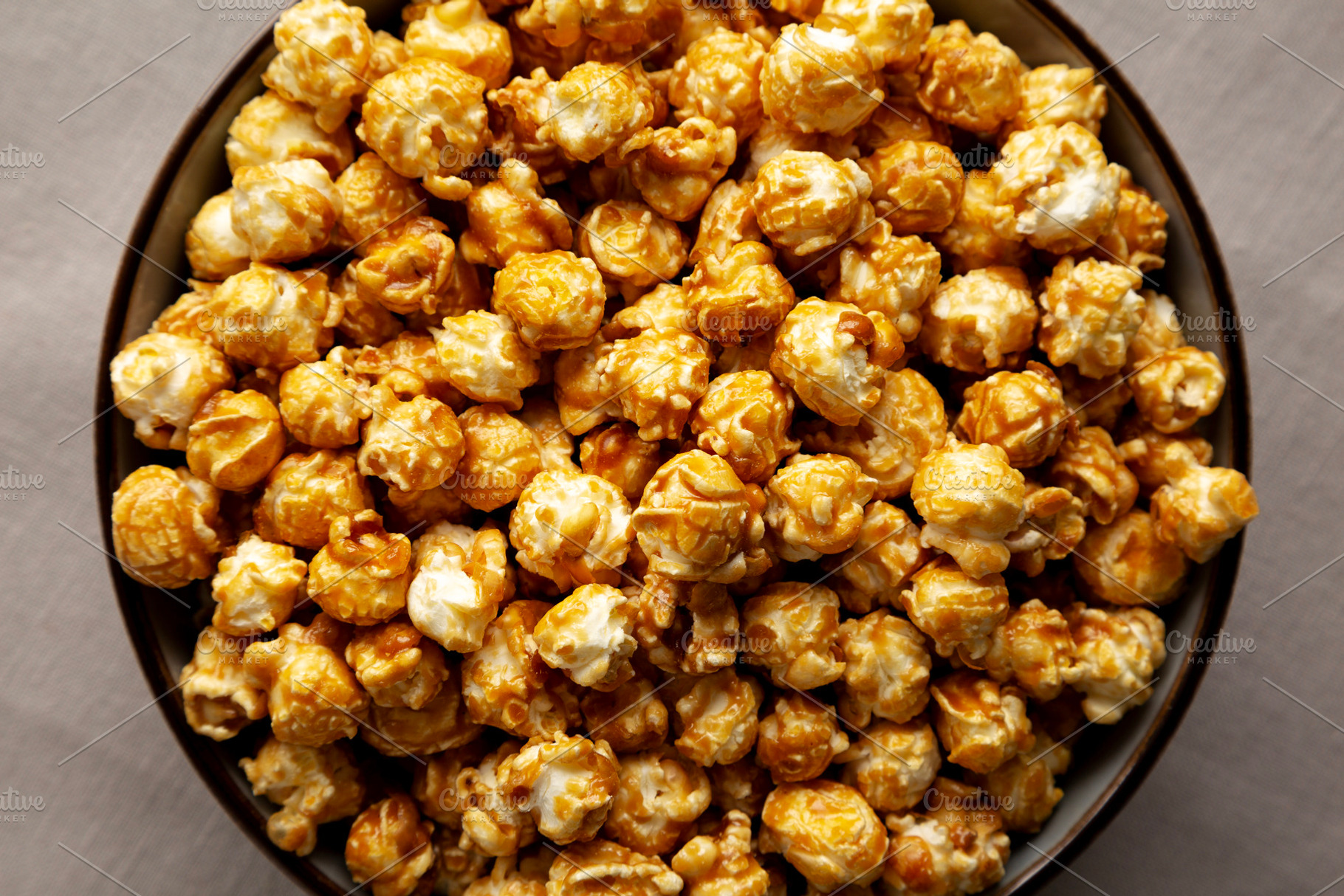 Homemade Caramel Pop Corn in a Bowl, top view., a Food & Drink Photo by LiudmylaChuhunova