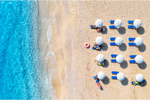 Aerial view of sunbeds under, a Nature Photo by den-belitsky