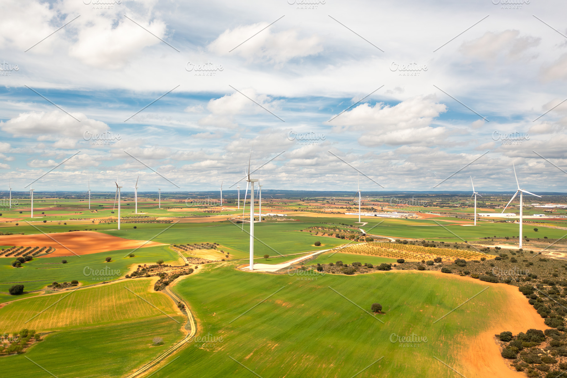 Aerial view of wind turbines in expansive green fields, a Photo by andreonegin market
