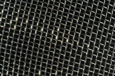 Monochrome texture of a shiny metal colander or grate. Abstract, an Abstract Photo by Eugene_Photo