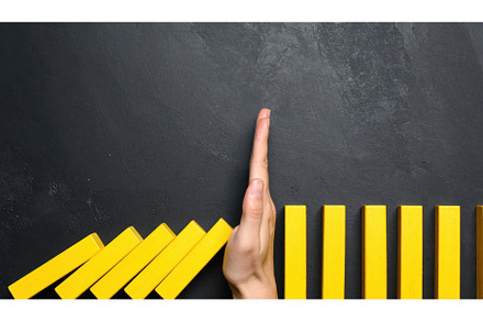 Hand stopping falling blocks as a, a Business Photo by Igor Tichonow