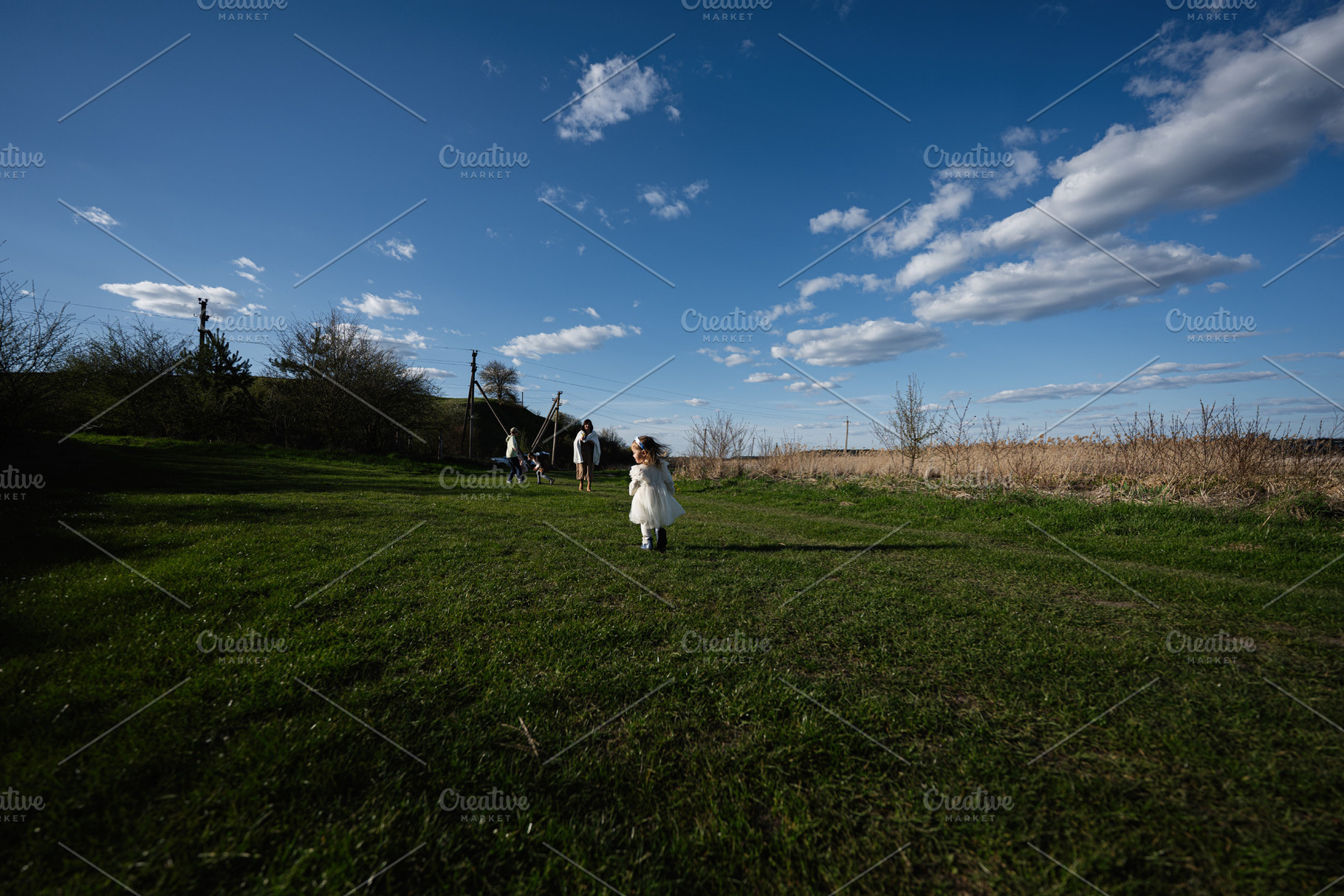 Family outing in the countryside with a little girl in a white dress running ac, a Person Photo by AS photostudio