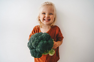 Child with broccoli vegetable healthy food vegan cooking eating sustainable lif