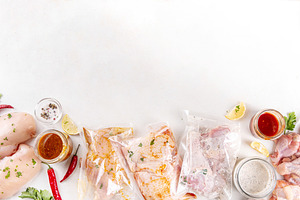 Several bags of marinated chicken meat, a Food & Drink Photo by Rimma