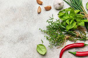 Fresh herbs and spices on gray background for healthy cuisine, a Food & Drink Photo by Olena Rudo