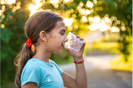 A child drinks water from a glass, a Person Photo by yanadjana