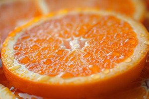Close-up of vibrant orange slices glistening with droplets of wa, a Food & Drink Photo by ImageMir