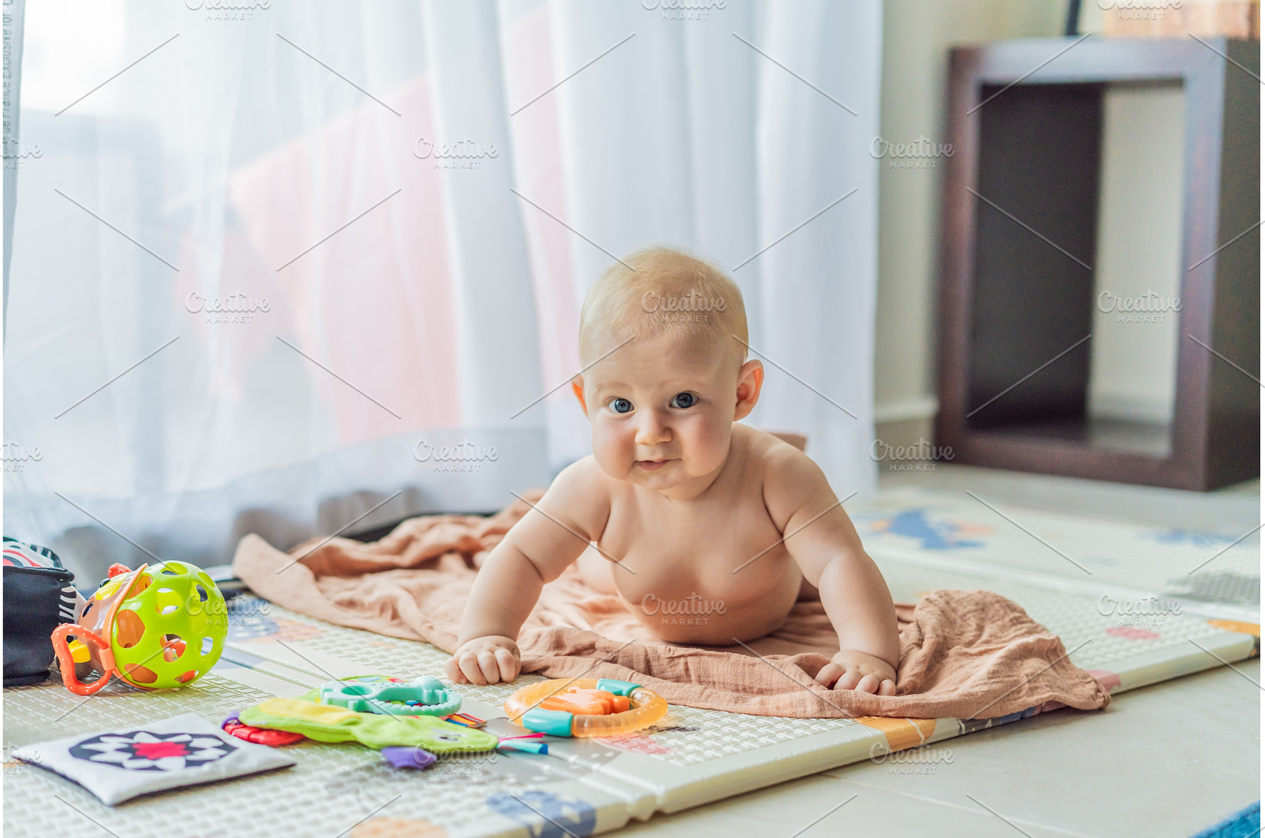 Little baby playing with toys on a, an Architecture Photo by Elizaveta Galitskaya