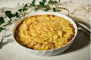 Golden gratin on a rustic table., a Food & Drink Photo by IlliaBondarPhotography