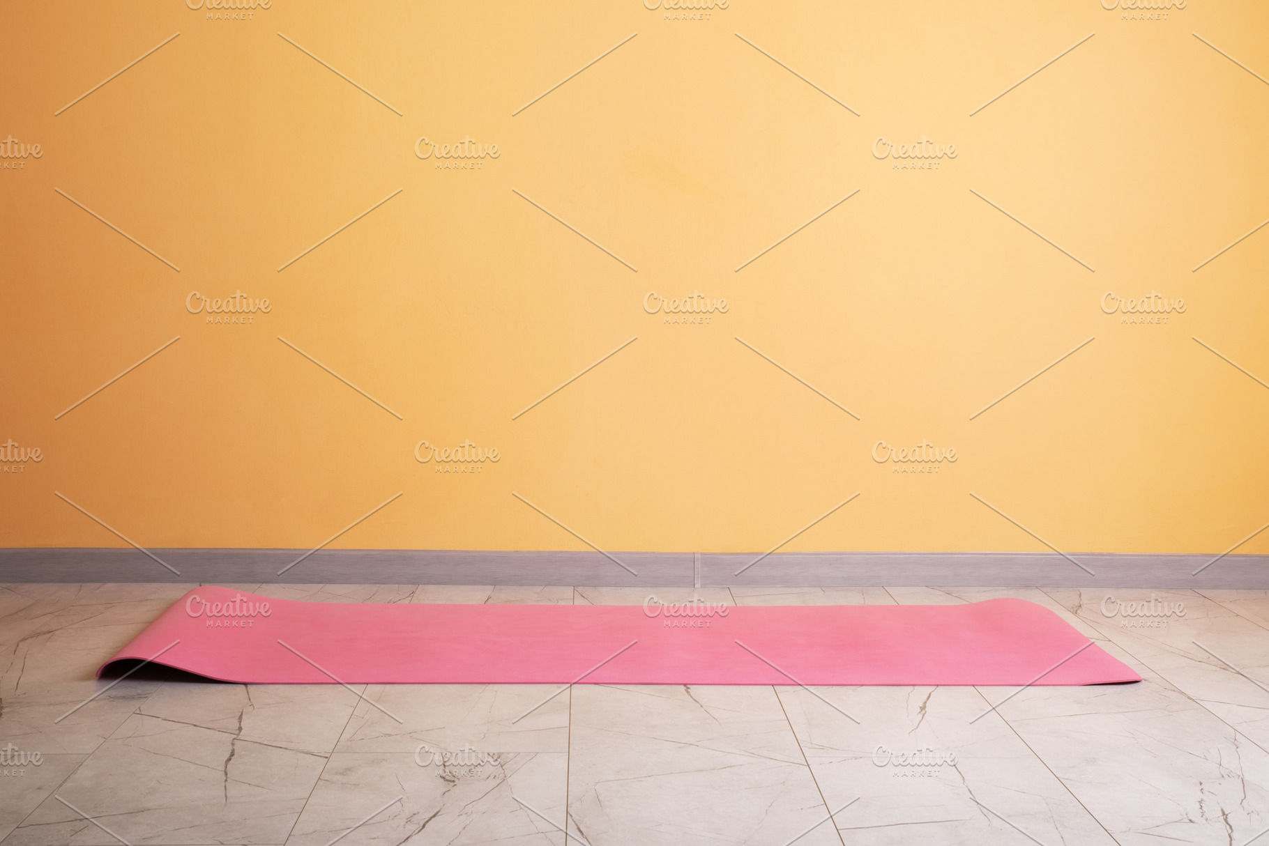 Minimalist pink yoga mat on a marble tile floor against a warm y, a Sports & Recreation Photo by Ales Munt