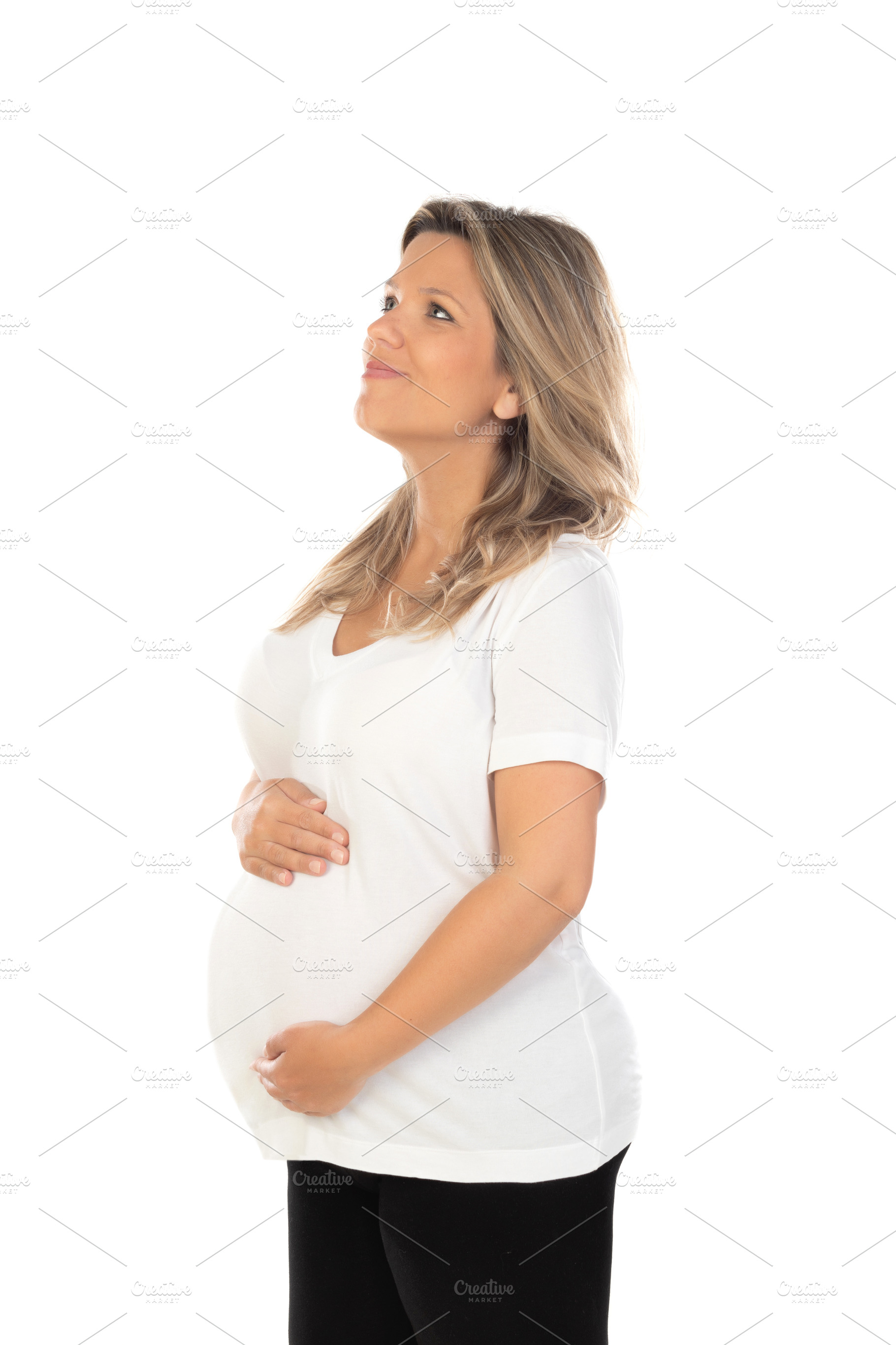 Young beautiful blonde woman pregnant expecting baby over isolat, a Person Photo by José Manuel Gelpi