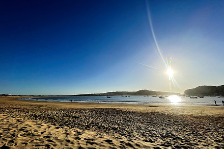 Golden beach at sunset in Cascais ,Portugal during a serene evening, a Photo by AS photostudio