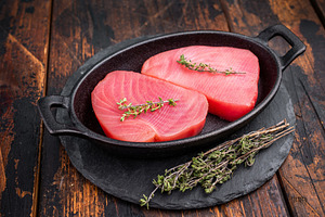 Vibrant raw tuna steak, showcasing its deep red hue, an essentia, a Food & Drink Photo by composter-box@mail.ru