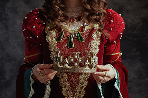 medieval queen in red dress with crown, a Person Photo by Alliance Images