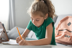 Schoolgirl doing homework at home, a Person Photo by etorres69