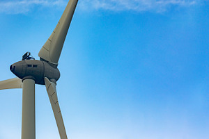 Close-up of a wind turbine with clear blue sky, symbolizing clean energy and su, a Technology Photo by Ales Munt