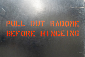 Aircraft fuselage warning message with red stencil lettering, a Background Photo by GoodGoods