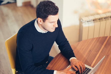 Man working at computer containing computer, laptop, and man